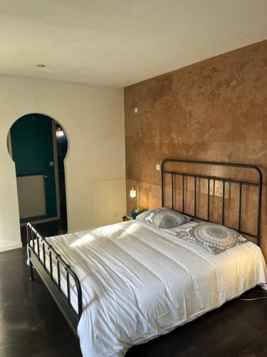 une chambre avec un grand lit dans une pièce dans l'établissement Maison Bonnefoy, à Toulouse