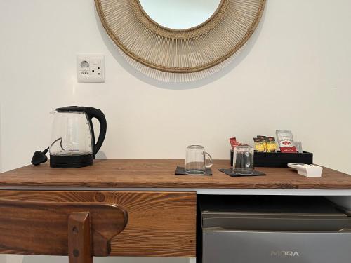 a counter with a blender and a mirror on the wall at The Lookout Guesthouse in Uvongo Beach