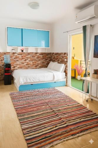 a bedroom with a bed and a large rug at Wavesong Whispers flat where you can enjoy seaview with the best price and enjoy speedy wifi for forigners only ممنوع المصريين in Hurghada
