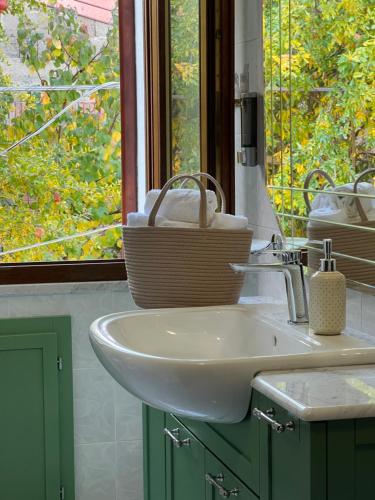 a bathroom with a sink and a window at Corte 'e Susu - Domo Experience in Ortueri