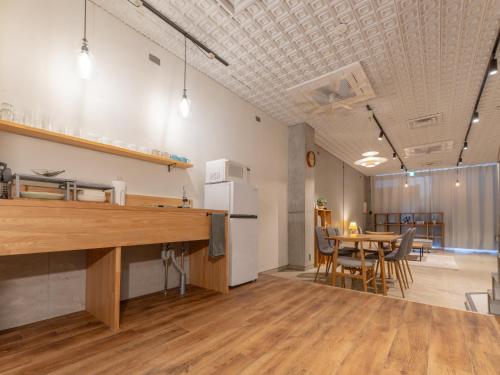 a kitchen and dining room with a table and chairs at Hotel art rock in Takamatsu