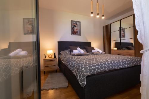 a bedroom with a bed and a mirror at Apartman Manči in Zaprešić