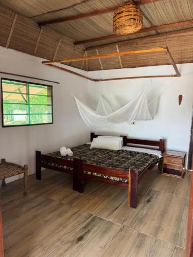 Postel nebo postele na pokoji v ubytování NANTIRIA Angurman