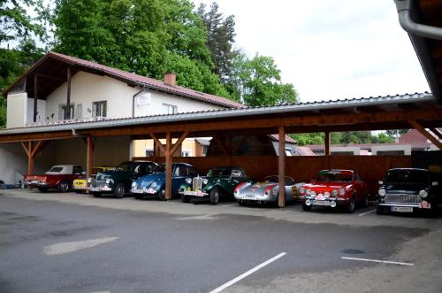 a group of cars parked in front of a building at Pension Sandhof in Knittelfeld