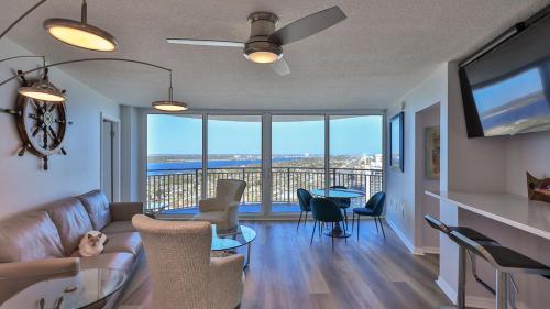 a living room with a couch and a table with chairs at On the Beach-2/Br 2/Bath, 26th floor! Spectacular views of Ocean & River in Daytona Beach Shores