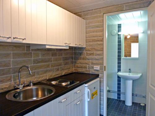 a small kitchen with a sink and a sink at Käringsund Resort in Eckerö