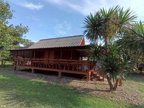 a building with palm trees in front of it at Doisaket hills in Doi Saket