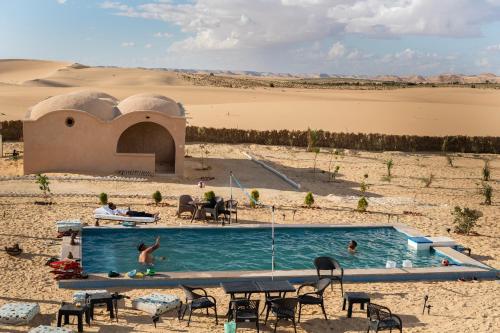 a swimming pool in the middle of a desert at Soléi Desert Retreat in siwa oasis