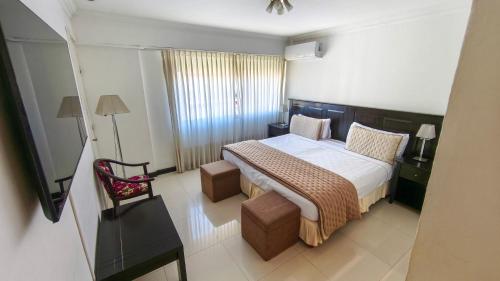 a hotel room with a bed and a chair at Argentino Hotel in Mar del Plata