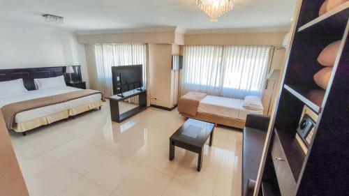 a hotel room with two beds and a television at Argentino Hotel in Mar del Plata