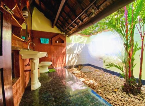 a bathroom with a toilet and a sink at Emerald Isle in Alleppey