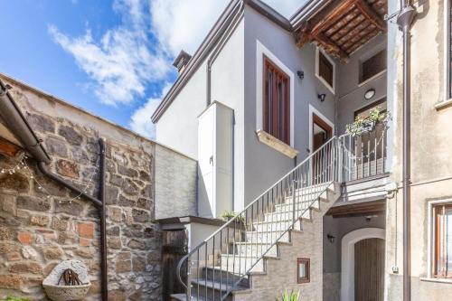 a white house with stairs and a stone wall at Casicarillo 800 in Serino