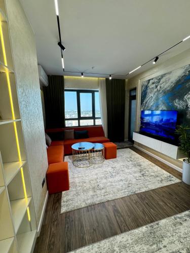 a living room with a couch and a table at Luxury apartment at 16th floor of Akay city in Tashkent near metro in Salor Bekati