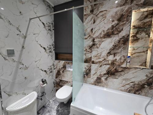 a bathroom with a sink and a toilet and a tub at Luxury apartment at 16th floor of Akay city in Tashkent near metro in Salor Bekati