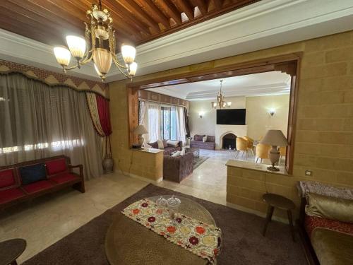 a large living room with a table and a living room at Dar Salma in Tangier