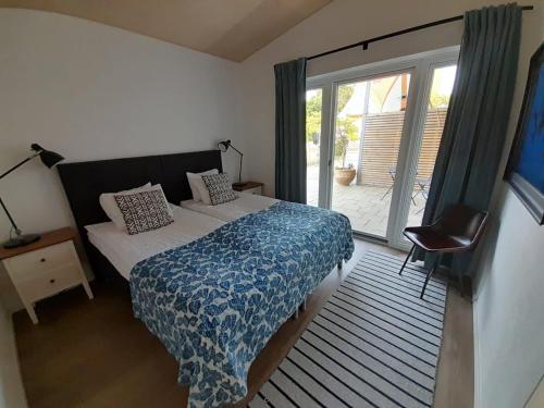 a bedroom with a bed and a large window at Studio apartment in Kivik in Kivik