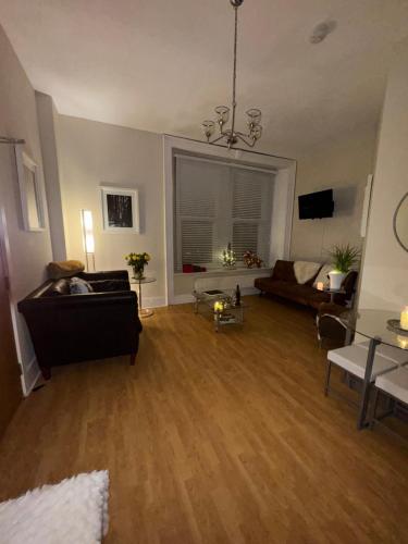 a living room with a couch and a table at NEWLY REFURBISHED NOV 2025 Chic City Stay In Jesmond Apartment in Jesmond