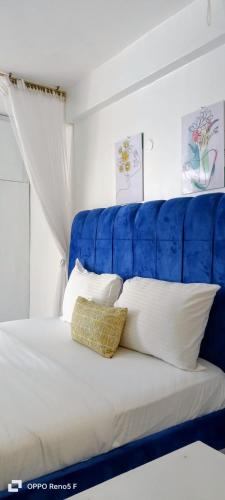 Ένα ή περισσότερα κρεβάτια σε δωμάτιο στο Kisumu Cosy Stay