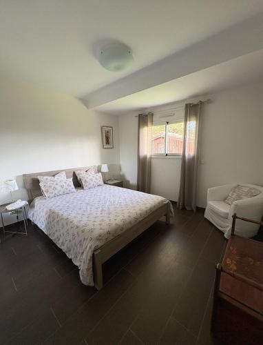 a bedroom with a large bed and a couch at Villa La Hispañola in Arès