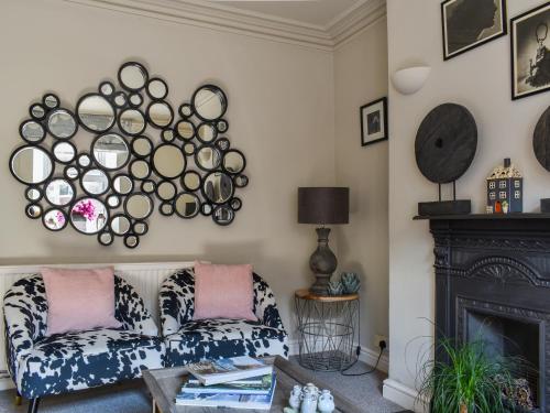 a living room with a couch and a fireplace at Beval Cottage in Abergavenny