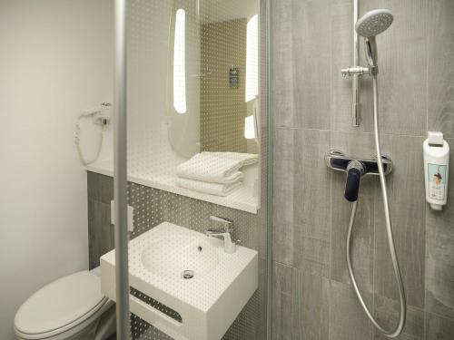 a bathroom with a toilet and a sink and a shower at ibis Lyon Gerland Merieux in Lyon