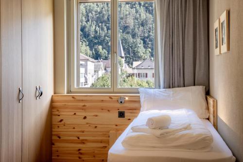 Postel nebo postele na pokoji v ubytování SWISSPEAK Resorts Meiringen