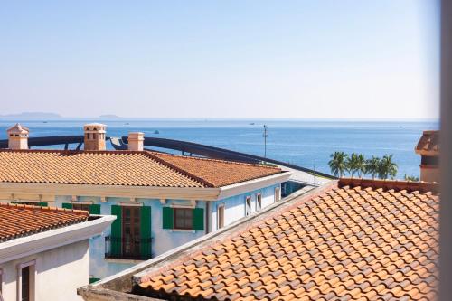 uitzicht op de daken van gebouwen met de oceaan op de achtergrond bij Lotus Home Cafe in Phu Quoc