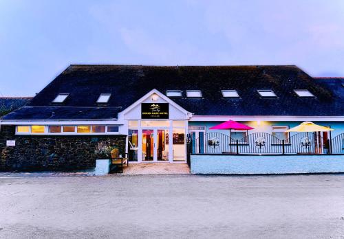 a building with umbrellas in front of it at Ocean Haze Hotel in St. Davids