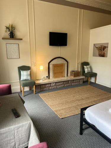 a hotel room with a bed and a fireplace at Edinburgh Travel Guest House in Edinburgh