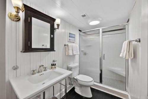 a bathroom with a toilet and a sink and a shower at PW1369: 1369 Pelican Watch in Seabrook Island