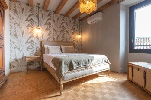 a bedroom with a bed and a wall mural at Torra di l alba in Viggianello