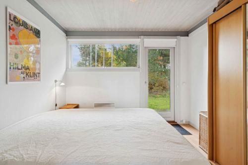 a bedroom with a large bed and a window at Well-Designed House In Scenic Surroundings in Martofte