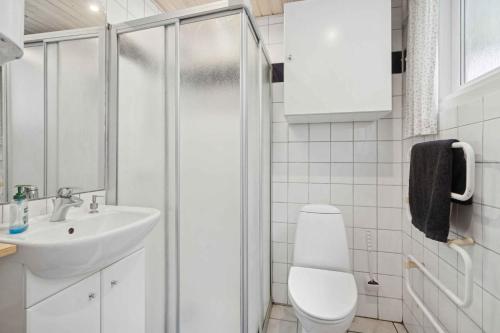 a bathroom with a toilet and a sink and a shower at Well-Designed House In Scenic Surroundings in Martofte
