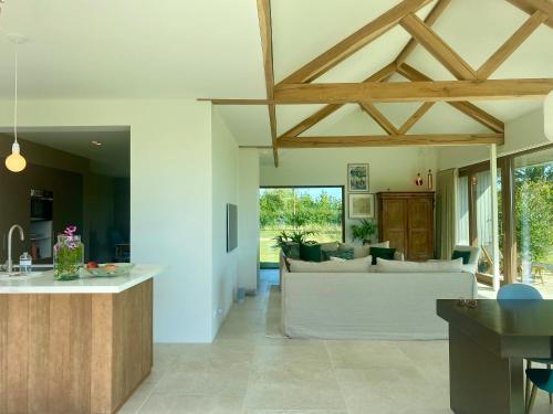a kitchen and living room with a couch and a table at Villa Alba, Walcheren in Gapinge