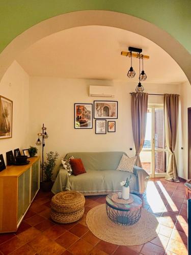a living room with a couch and a table at Brezza Calabra Sea View Apartments in Scalea
