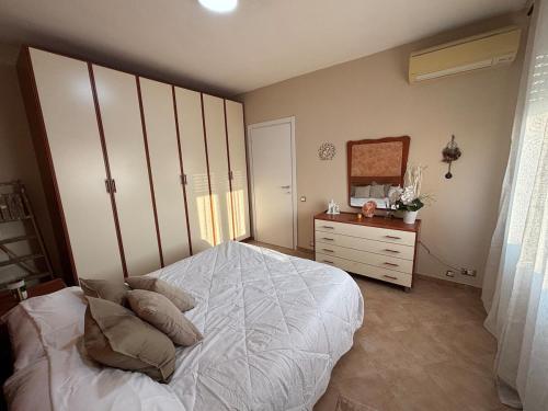 a bedroom with a bed and a dresser and a mirror at Modern Apartment - MIND District, Fiera Milano Rho in Baranzate