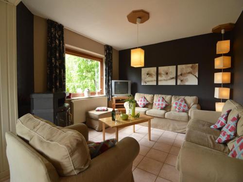 a living room with two couches and a tv at Ondenval Stay with Sauna in Waimes