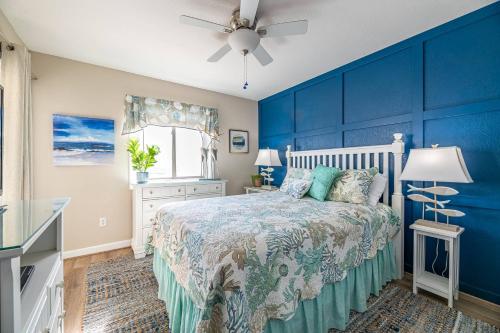 1 dormitorio azul con 1 cama y ventilador de techo en Perfect Ocean View - The Sands - K0003A, en Croatan Shores