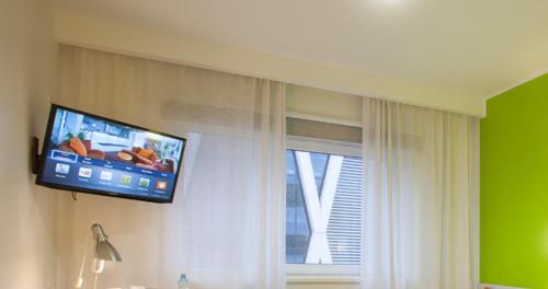 タリンにあるタリンク エクスプレス ホテルの部屋の窓に置かれた薄型テレビ