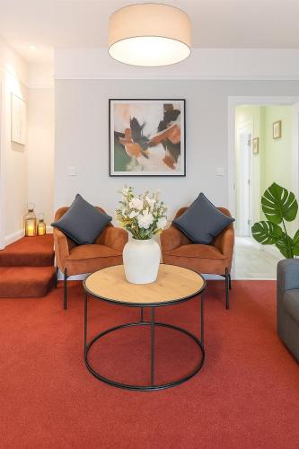 a living room with a vase of flowers on a table at Sunnyholme - New! Yorkshire Luxurious Cottage in Hawes