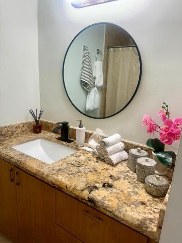 a bathroom with a sink and a mirror at The Hollywood Beach Experience in Hollywood