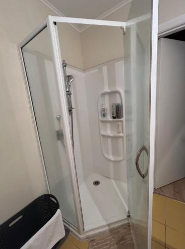 a shower with a glass enclosure in a bathroom at Auckland Northcote Holiday home in Auckland