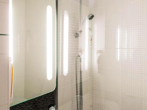 a bathroom with a shower with a glass door at ibis Bourg en Bresse in Bourg-en-Bresse