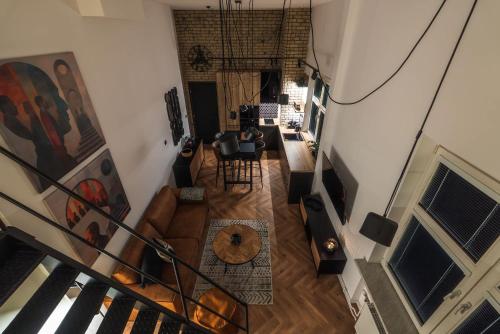 an overhead view of a living room with a staircase at Central Designer Loft - Modern & Chic in Staré Mesto