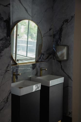 a bathroom with two sinks and a mirror at WL Hotel Maputo Executive in Maputo
