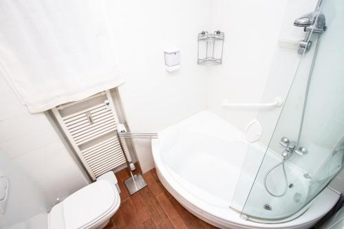 a bathroom with a toilet and a glass shower at La Casa di Paola in La Thuile