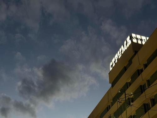 a building with a sign on the top of it at Struma Hotel in Pernik