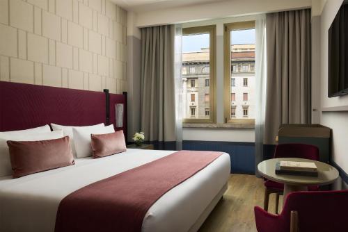 a hotel room with a bed and a window at Tivoli President Milano Hotel in Milan