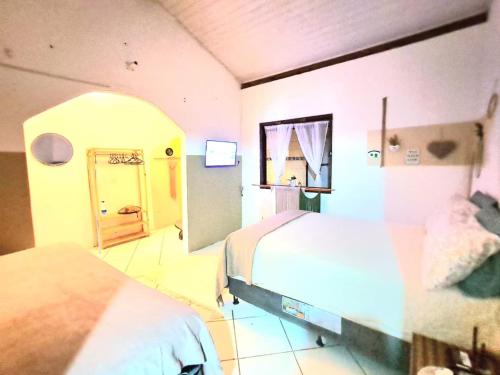 En eller flere senge i et værelse på Chalezinho D'Ajuda