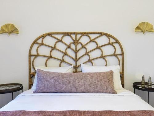 a bedroom with a large white bed with a wooden headboard at Astris Suite, Mansion Double Room, Imerovigli in Imerovigli